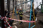 Serhii Shova (center) is a squad commander of an emergency crew that has been working at the site since Saturday.