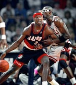 FILE - In this June 4, 1992, file photo, Portland Trail Blazers' Cliff Robinson drives on Chicago Bulls' Horace Grant during Game 1 of the NBA Finals in Chicago. Dennis Rodman has named a team of former NBA players to participate in an exhibition basketball game in Pyongyang, North Korea. Rodman leads a team that includes former NBA All-Stars Kenny Anderson, Robinson, and Vin Baker. Craig Hodges, Doug Christie and Charles D. Smith are on the team, as well. They will play against a top North Korean Senior National team on Jan. 8, marking Kim Jong Un's birthday. (AP Photo/John Swart, File)