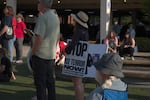 A rally-goer holds a sign saying, "Stop ICE terror now!" in Springfield on Aug. 14, 2026.