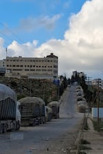 Garbage trucks are parked outside the transfer station waiting for the optimum time to try to get through all the additional Israeli checkpoints set up around the West Bank since October 7, 2023.