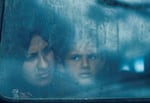 Displaced Palestinians look out from a bus window in Rafah on Saturday, March 9.