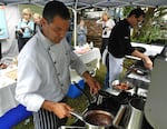 Chefs Hamid Serdani, left, and Jason Biga compete in an invasive species cookoff in Philomath, Ore.