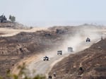An Israeli army convoy leaves the Gaza Strip as seen from a position on the Israeli side of the border on June 17, in southern Israel.