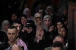 A woman grieves during the funeral for three Palestinian militants killed in an Israeli military operation in the West Bank town of Qabatiya, Friday, Sept. 20, 2024.