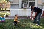Brandon Cunningham, with his youngest son, has a good-paying job now and watches his savings grow. "I never thought I could be this guy. But, hey, here I am."