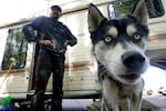 Phil Wheeler and his dog, Nico, outside his RV in Clackamas County, Ore. on Sept. 20, 2024.