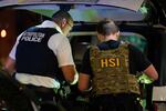 Metropolitan Police Department and Homeland Security Investigations officers search inside a car during a traffic stop on Aug. 14, 2025, in Washington, D.C.