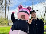 Lacy, often seen as the Pink Frog at protests at the Portland CE building, poses for a picture near OPB with her husband, Jordy Lybeck. The couple appeared on “Think Out Loud” on Monday, March 30, after the “No Kings” series of protests in Portland and in cities all over the country.