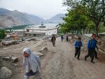 School children head home near the village of Machulo, where the changing climate has meant more flooding, less snowfall — and less spring snowmelt to feed local waterways.