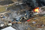 FILE - Debris from a Norfolk Southern freight train lies scattered and burning along the tracks on Feb. 4, 2023, the day after it derailed in East Palestine, Ohio.