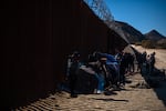 Coyotes drop off migrants at a miles-long gap in the border wall in the Southern California desert, on the outskirts of Jacumba. One of the camps that has sprouted up is on private property.