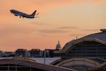 A flight takes off from Ronald Reagan Washington National Airport in Arlington, Va., on Tuesday, with the U.S. Capitol in view.