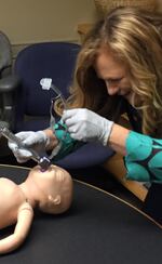 Dr. Jeanne-Marie Guise practices intubating a baby. She says sometimes such complicated medical equipment doesn't work as well as it could on a small child.