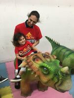 Uhusti Gause with his son, Uhusti Jr., who loves dinosaurs.