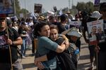 Meirav Leshem Gonen (left), whose daughter Romi is being held hostage in Gaza, embraces Sharon Alony Cunio, who was kidnapped and released from captivity along with her two children and whose husband, David, remains hostage, as the march to Jerusalem passes Kibbutz Sa'ad in southern Israel on Feb. 28.