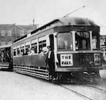 This image, circa 1905, shows an electric trolley car taking passengers to "The Oaks" amusement park.