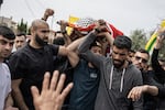 Mourners carry the body of 14-year-old Palestinian Amir Rabee, a U.S. citizen, during his funeral in the village of Turmus Ayya, in the Israeli-occupied West Bank, on Monday.