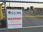 In this Sept. 8, 2024 photo an EPA warning sign has been posted on the gates of the shuttered J.H. Baxter wood treatment plant. EPA officials are seeking to have the site put on the Superfund list, to fund cleanup.