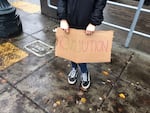 A seventh grader at Metropolitan Learning Center holds a sign reading "Revolution" during the Portland Public Schools student walkout, November 14 2016. 