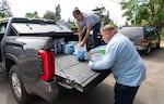 In Portland, donations are gathered to support Warm Springs residents impacted by the Bench Fire. Loretta Guzman, left, and Gilbert Brown, unload baby wipes, toothbrushes and other supplies donated by Painted Horse Recovery and dropped off at the Bison Coffee House in Portland, Ore., on July 28, 2026. 