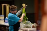 Nicholas Numkena-Anderson, Alexa's husband and operations manager for Javelina, examines a bunch of wild leeks, pulling stands out that are damaged, before chopping and charring them for dishes like the "Sunchoke and Corn Truffle Banaha" and "Three Sisters Baked Potato."