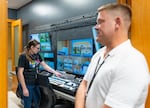 Davina Krug, left, and James Apple, city technology supervisor, in the technology control room in City Hall, Aug. 18, 2026.