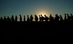 Migrants who crossed the Rio Grande and entered the U.S. from Mexico are lined up for processing.