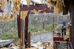 Robert Fraser surveys damage to a warehouse after a tornado passed through an industrial industrial park in Jeffersontown, Ky., in April 2025.