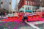 White Lotus Dragon and Lion Dance founder Nhan Danh, center, poses in front of lions during a celebration of Tết , the Vietnamese Lunar New Year.