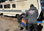 Phil Wheeler removes items from a friend's abandoned motorhome on Clackamas Road on Sept. 30. 2024. The Clackamas County Sheriff's Office eventually towed the motorhome.