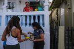 Norimar Maldonado and other participants of Saturday's "sancocho comunitario" event, hosted by Huerto Callejón Trujillo, deliver food door to door in Ponce Playa.