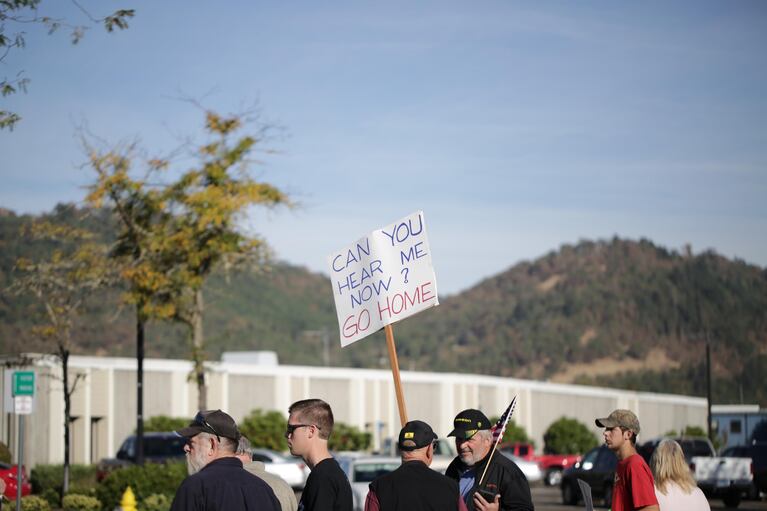 Protestors await the arrival of President Barack Obama.