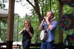 Nicky Sanders, left, plays the fiddle while Graham Sharp, right, plays a harmonica solo on the main stage with North Carolina-based Steep Canyon Rangers. The band won a Grammy for Best Bluegrass Album in 2013.