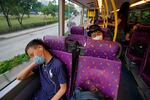 Passengers sleep on the upper deck of a double-decker bus in Hong Kong.