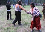 A California woman who goes by "It's Not Lit" fist bumps with a fellow participant at the gathering of the Rainbow Family of Living Light in the Malheur National Forest. 
