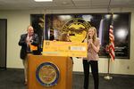 Governor Kate Brown, center, announces Chloe Zinda of McMinnville, right, as the $1 million winner of the Take Your Shot Oregon campaign, July 9, 2021.