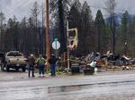 Blue River residents survey the remnants of a general store and neighboring homes, February 2021.