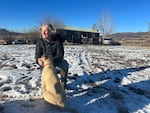 Jan Stanko poses with Samson, a livestock guardian dog she is training to protect the cows, pigs and sheep that live on the Stanko ranch in northwest Colorado., 