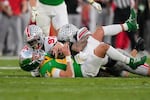 Ohio State defensive end Kenyatta Jackson Jr. (97) and safety Lathan Ransom (8) sack Oregon quarterback Dillon Gabriel (8) in the second half in the quarterfinals of the Rose Bowl College Football Playoff, Wednesday, Jan. 1, 2025, in Pasadena, California.