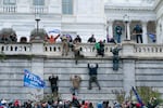 FILE - In this Jan. 6, 2021, file photo, violent insurrectionists loyal to President Donald Trump scale the west wall of the the U.S. Capitol in Washington.