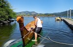 Hilario Ridout of the Quinault Tribe unloads the tribe's canoe of yellow cedar and yew wood, made by John Howard, at Wyeth in Hood River County, Ore., on July 19, 2023.