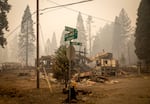 In this Sept. 15, 2020, file photo, scorched property stands at an intersection in Blue River, Ore., days after a blaze known as the Holiday Farm Fire swept through the area's business district.