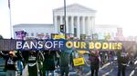 Pro choice demonstrators gather outside the Supreme Court as arguments on an abortion case are made inside.