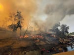 Rohingya refugees try to salvage their belongings after a major fire in their Balukhali camp at Ukhiya in Cox's Bazar district, Bangladesh, on March 5, 2023.
