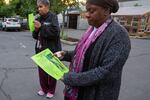 Kenya Robinson holds a flyer of her son Otis “TeTe” Michael Gulley at his prayer vigil. Gulley was found hanging in Rocky Butte on Memorial Day. The medical examiner ruled it a suicide but police have opened an investigation into the death.