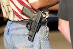 FILE - In this Oct. 9, 2015 file photo, a man wears a firearm in Roseburg, Ore.