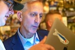 Portland Mayoral Candidate Keith Wilson, left, gets a look at initial returns from Cooper Bryant, senior policy communications advisor, at his election night party held at Old Town Brewing in Portland, Ore., Nov. 5, 2024.