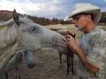 William Simpson with a 2-year-old Appaloosa colt near the Soda Mountain Wilderness area, straddling the Oregon and California border, in July 2022.