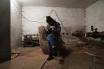 A woman holds her cat in a shelter during Russian shelling, in Mariupol, Ukraine, Thursday, Feb. 24, 2022. Russia has launched a barrage of air and missile strikes on Ukraine early Thursday and Ukrainian officials said that Russian troops have rolled into the country from the north, east and south.