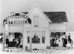 In this image, circa 1880s, Dr. Benjamin Russell and his family pose on the porch of their Lane County, Ore. home, which served as a county poor farm.